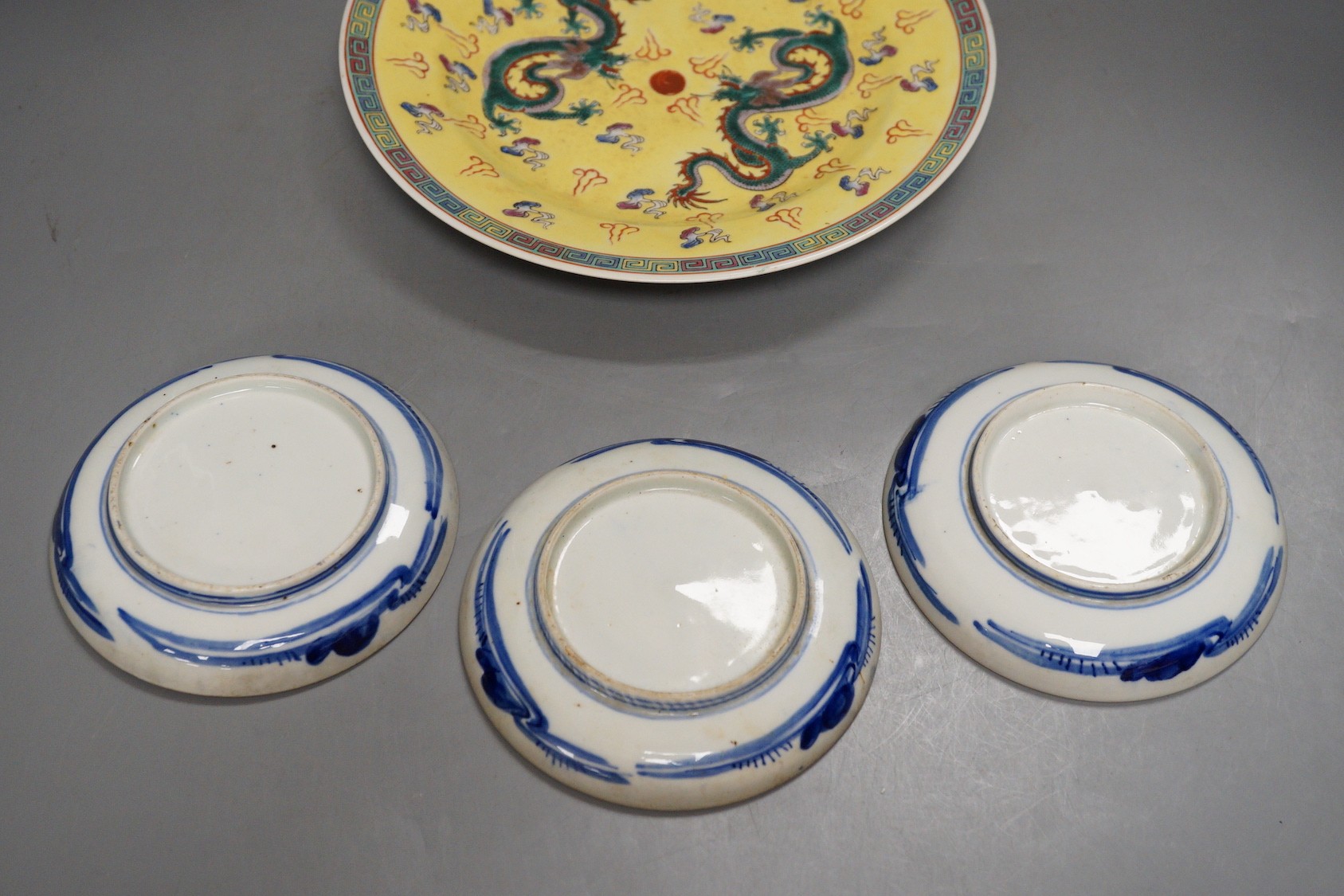 Three Japanese Arita dishes and a Chinese dragon plate, largest 23cm diameter